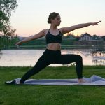 a woman does yoga in the countryside